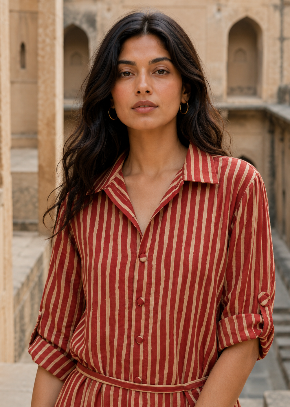 Woman wearing a red and white striped shirt in an architectural setting